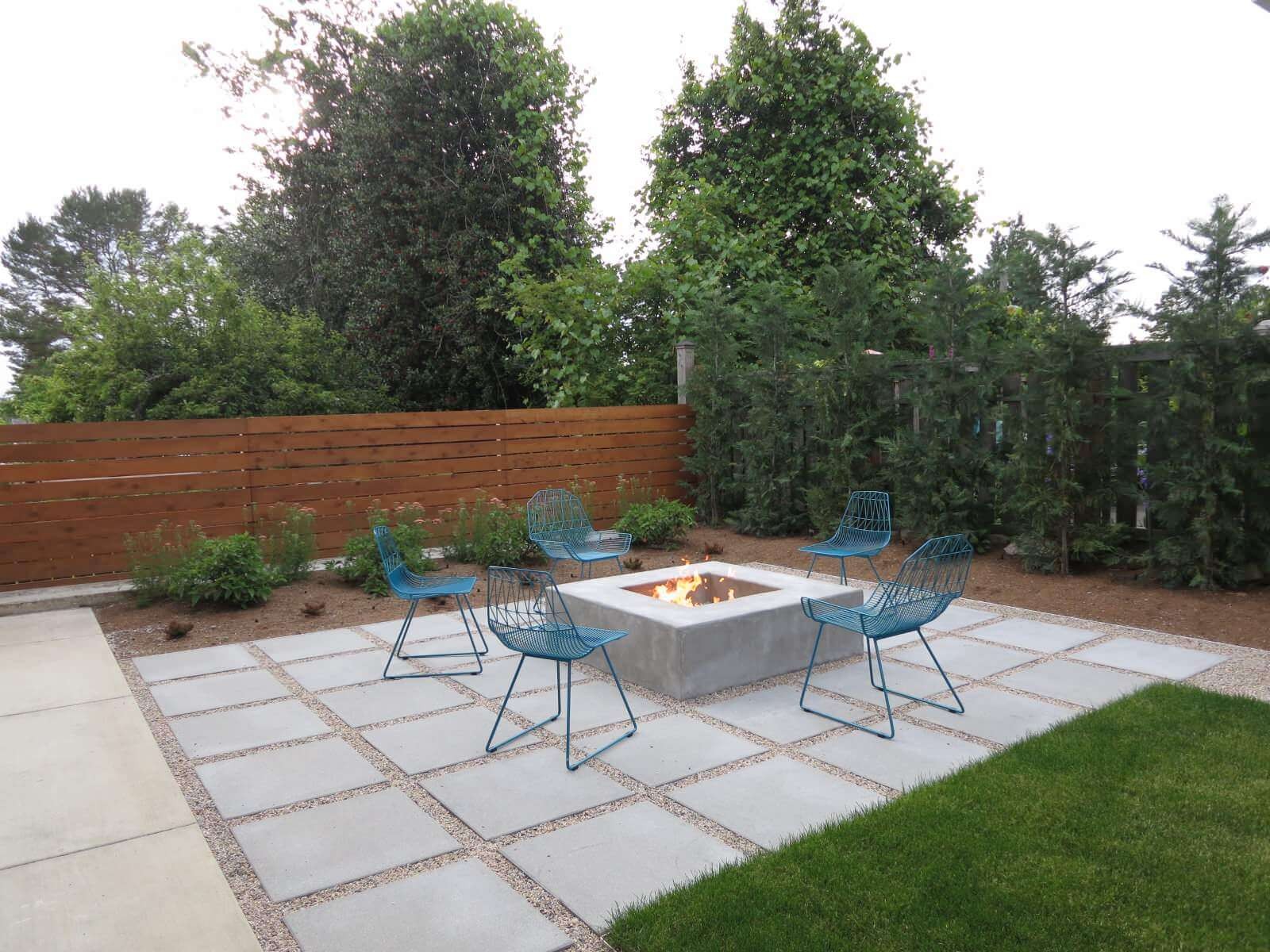 #3. Patio – contemporary backyard concrete paver patio idea with a fire pit