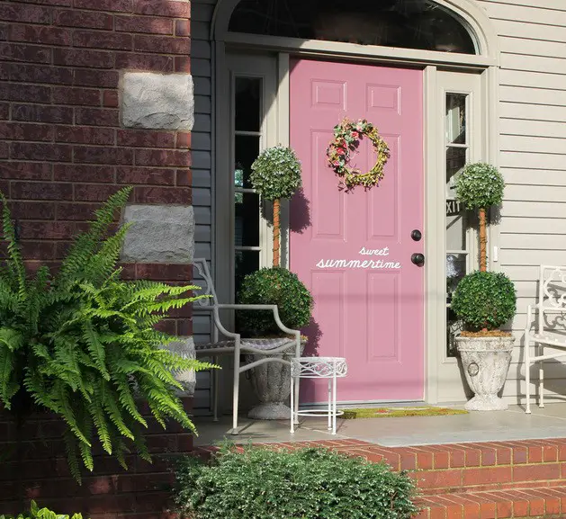 Pink front door with a hanging wreath