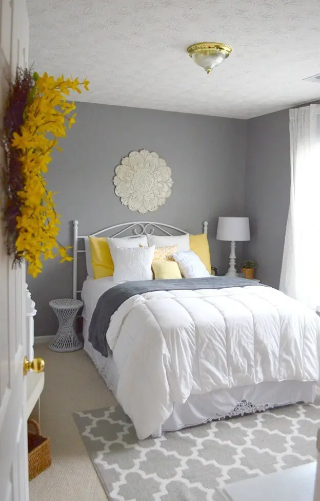 Grey and white guest room with a hanging wreath