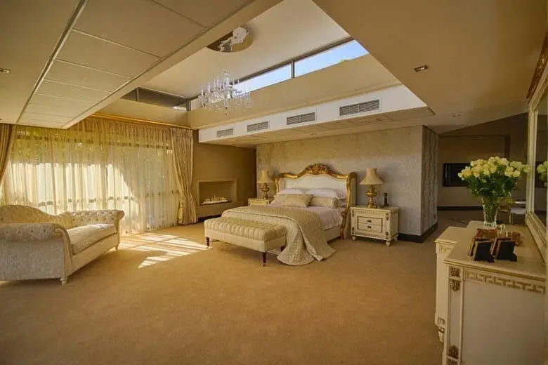 A large golden and white bedroom