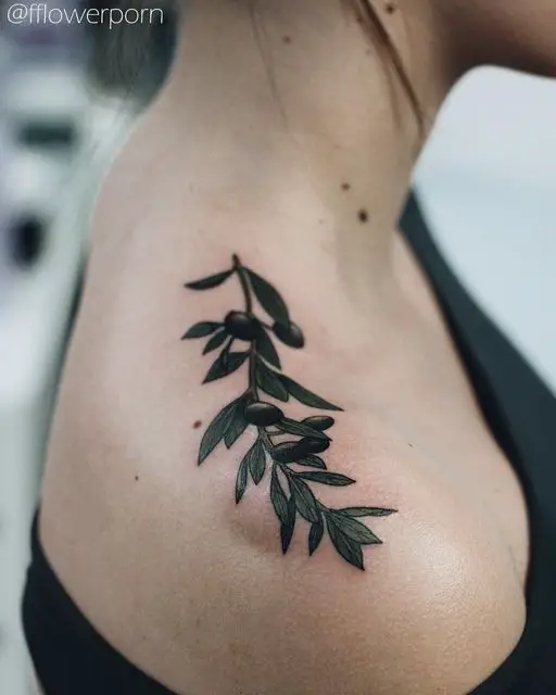 #2. The shoulder olive branch tattoo symbolizing peace and dignity.