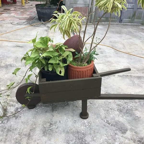 Small wooden wheelbarrow with plant vases