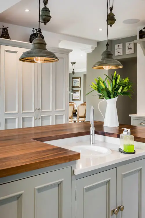 #13. Rustic Pendant Lighting in a Farmhouse Kitchen