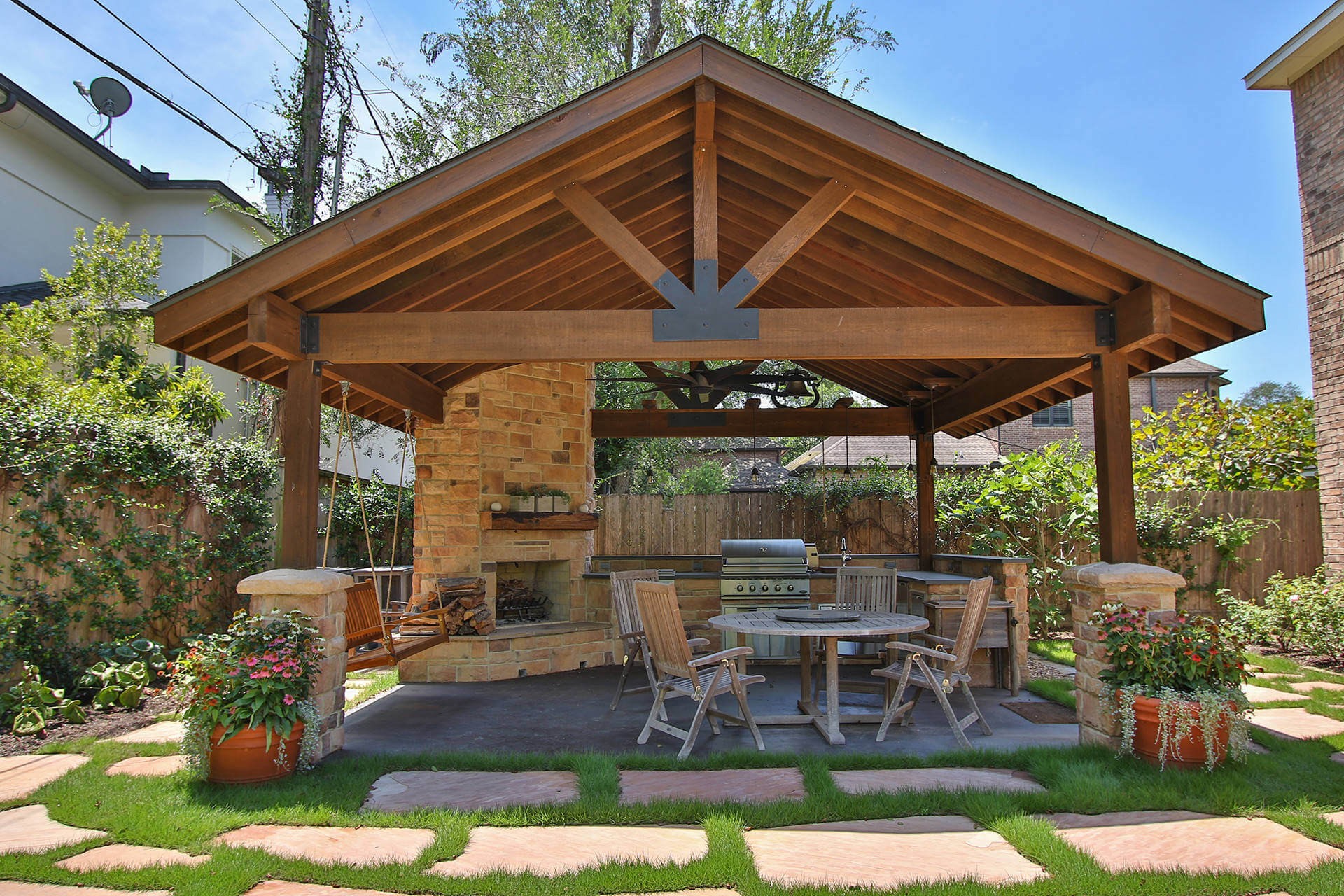 #10. Large mountain style backyard concrete patio kitchen with a gazebo